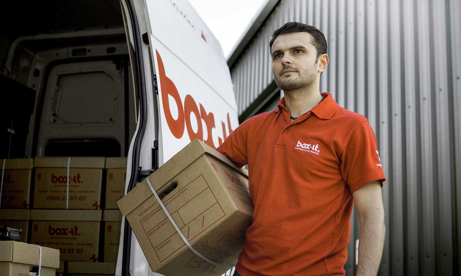 Box-it employee taking storage boxes into the van